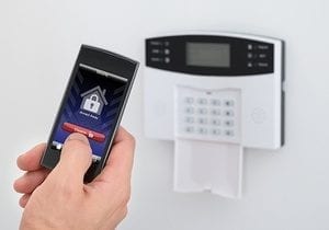 Security Alarm Keypad With Person Disarming The System With Remote Controller