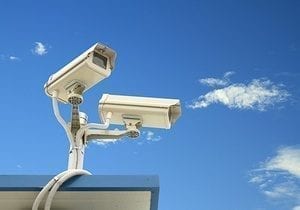 Security camera on blue sky background